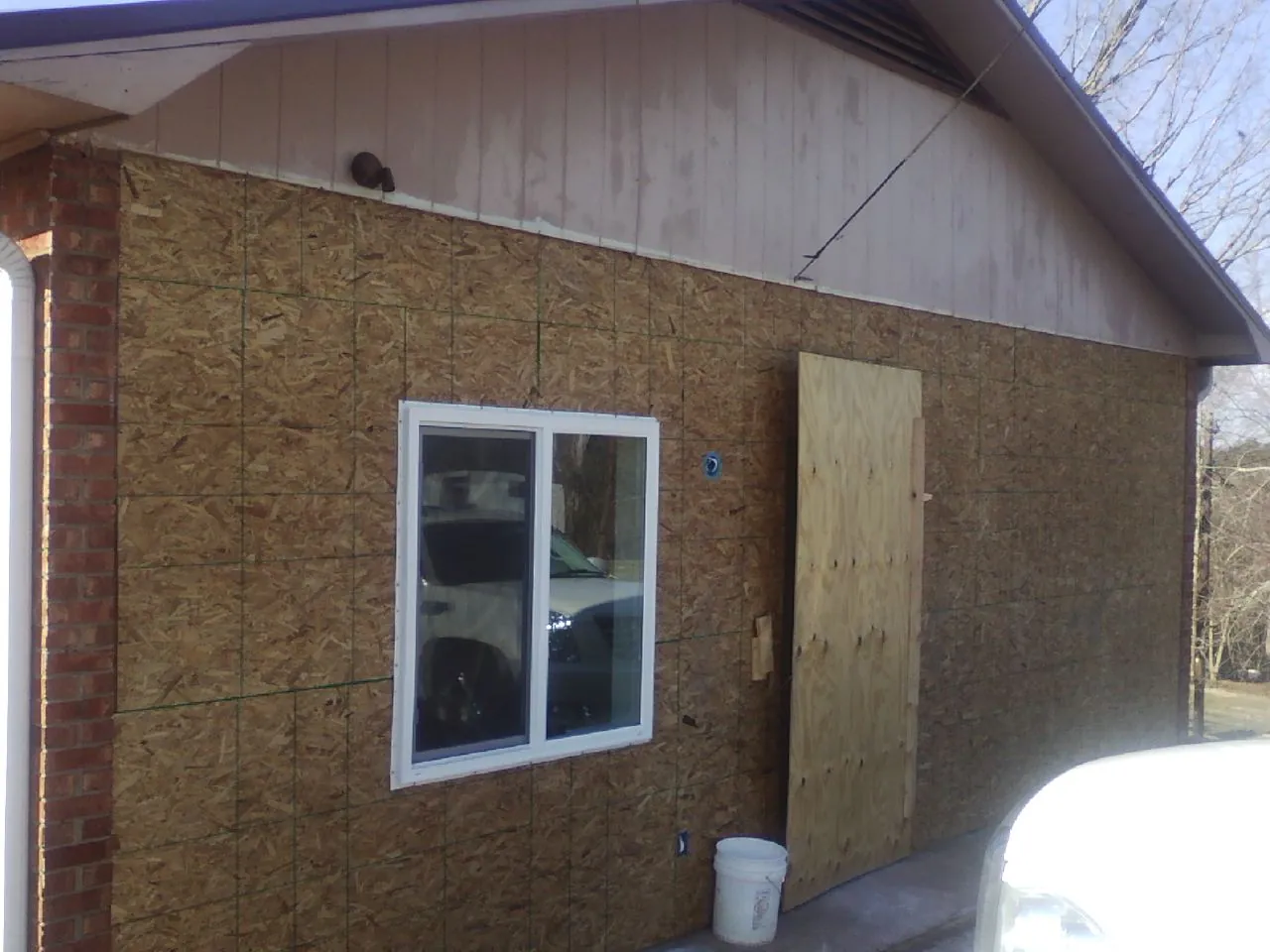 OSB sheathing on a garage addition wall before siding in Mount Enterprise