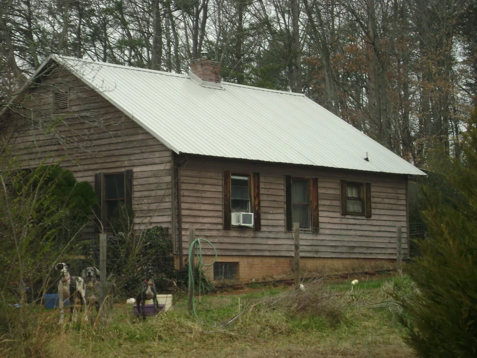 White metal roof on an old wood sided farmhouse, from a Metal Roof Installation job in Mount Enterprise